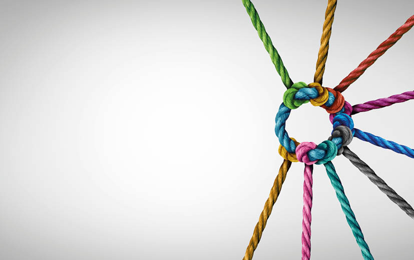 Unity and teamwork concept as a business metaphor for joining a partnership as diverse ropes connected together as a corporate symbol for cooperation and working collaboration 