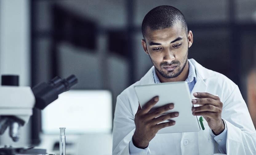 Shot of a scientist recording his findings on a digital tablet