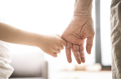 Grandparents and grandson playing at home - Grondson holding hand of his grandfather
