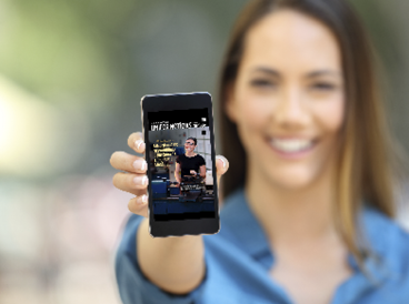 Girl hand showing a phone screen mock up on the street