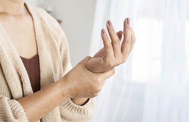 woman suffering from wrist pain, numbness, or Carpal tunnel syndrome hand holding her ache joint