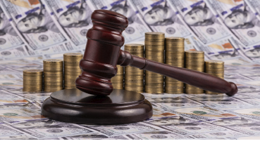 Judge's gavel, gold coins and 100 american dollar bills