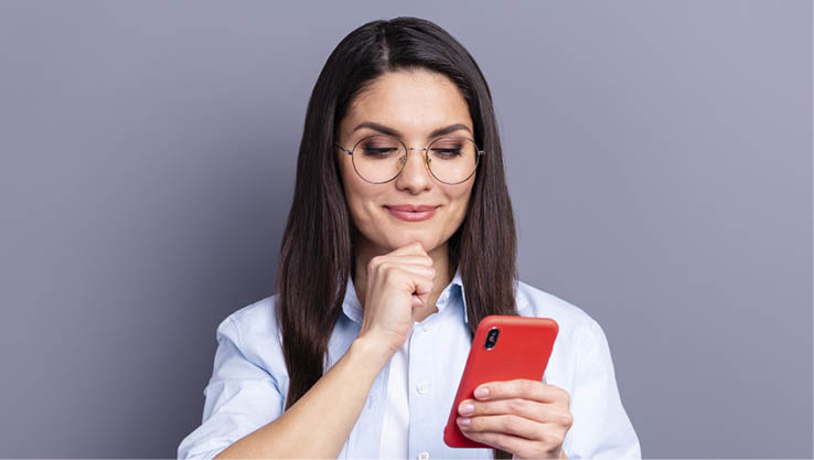 Photo of shiny cute young lady dressed blue shirt glasses arm chin reading modern gadget isolated grey color background.