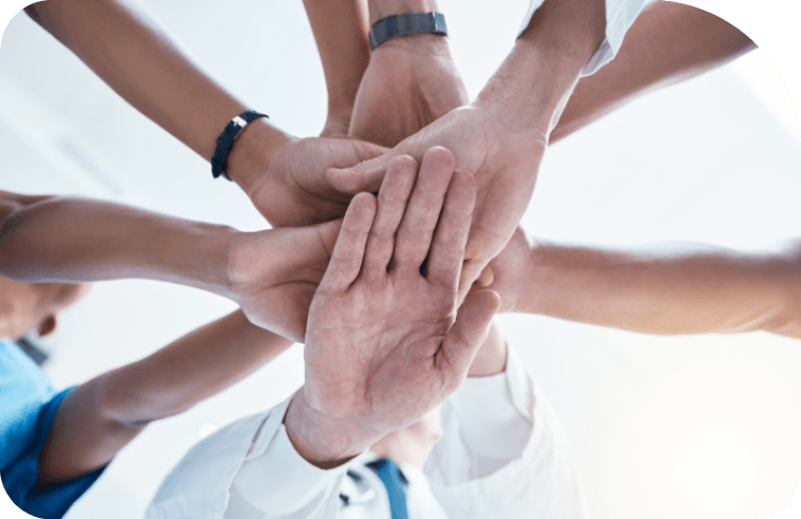 Below, group and hands stack for medical, staff and teamwork in hospital for motivation. Team, doctor and nurse with hand for collaboration, healthcare and help in community at job together in clinic