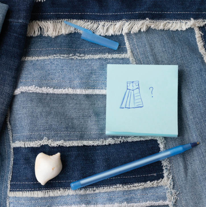 Old jeans ready to upcycling and pattern,  made from old jeans pieces, pen and note paper  Concept of things reuse and natural resources preserving 