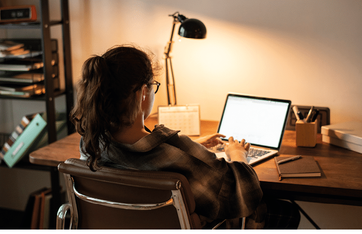 Teen girl doing homework on her laptop