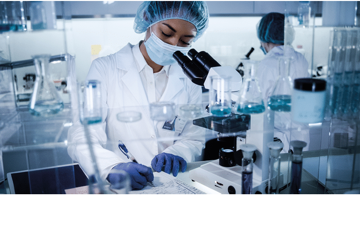 Scientists examines DNA models in modern Genetic Research Laboratory  Computer monitors with data in foreground