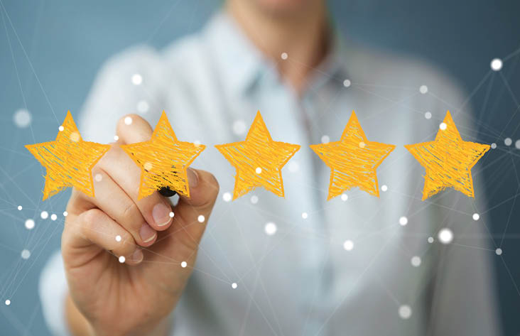 Businesswoman on blurred background rating with hand drawn stars