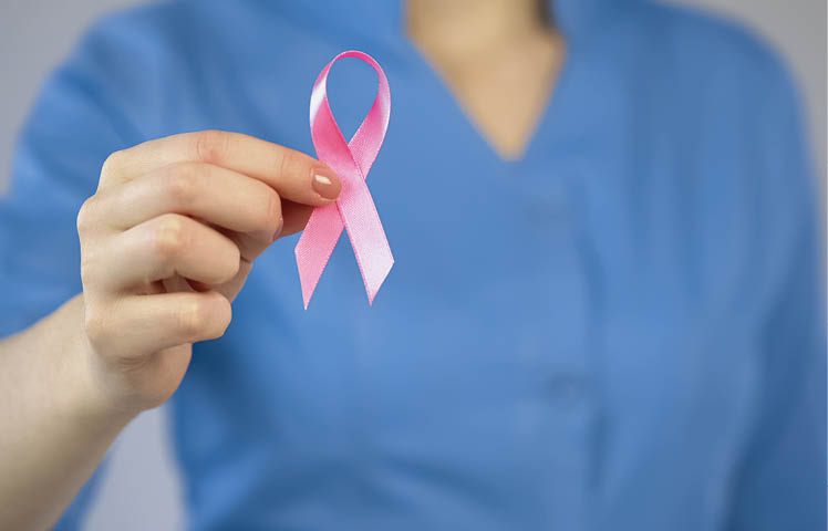 Doctor showing pink ribbon closeup, breast anticancer campaign, examination, stock footage