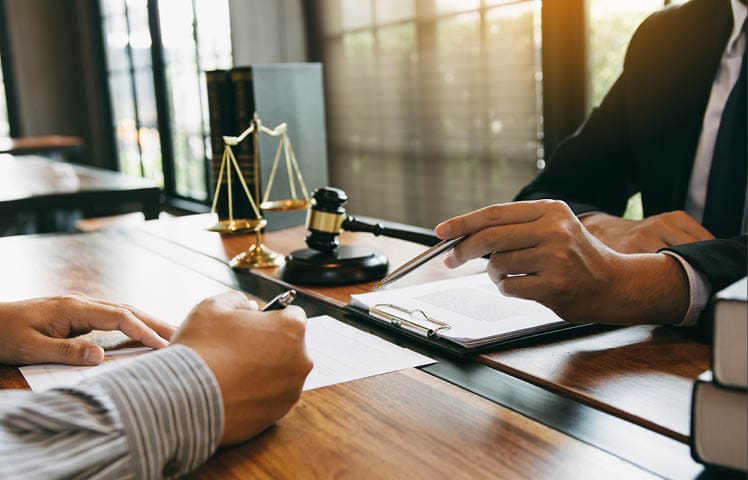 Lawyer is explaining about the wrongdoing laws regarding fraud to the client at the office 